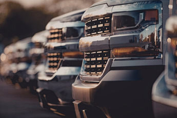 A line of pickup-trucks on a lot.
