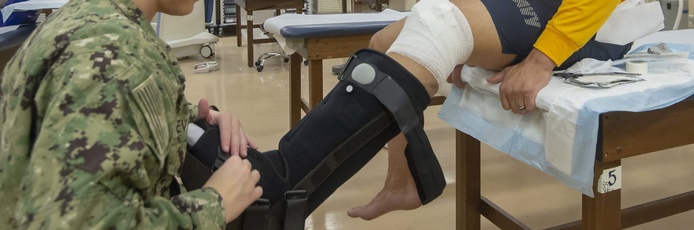 A person being fitted with a compression boot for an ankle injury