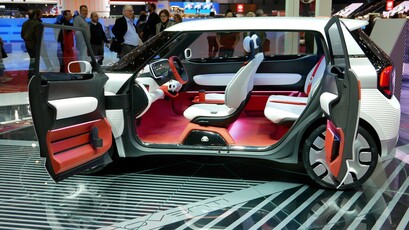 A white sports car with red seats and a futuristic design.